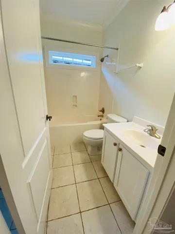 a room with wooden cabinets and a sink