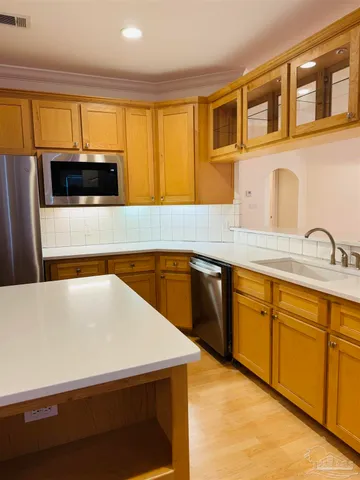 a kitchen with stainless steel appliances a stove a sink and a microwave