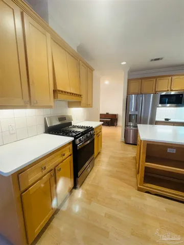 a kitchen with a stove and a refrigerator