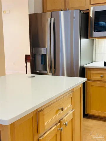 a kitchen with a refrigerator and a stove