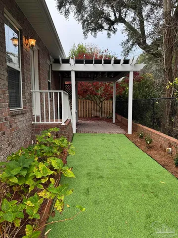 a view of a house with backyard and porch