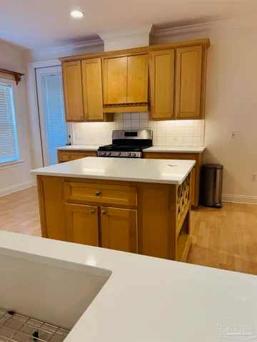 a kitchen with a sink a counter top space and a window