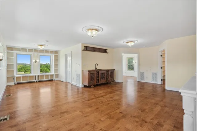 an empty room with windows and closet