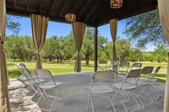 a view of a chairs and table in patio