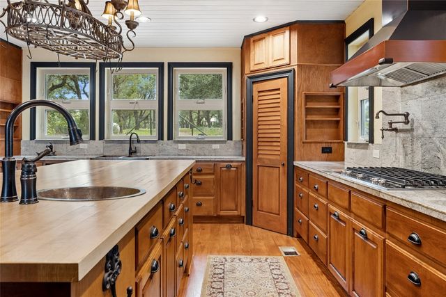 a view of a kitchen with refrigerator and window