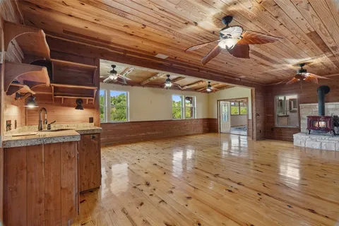 a view of a room with wooden floor