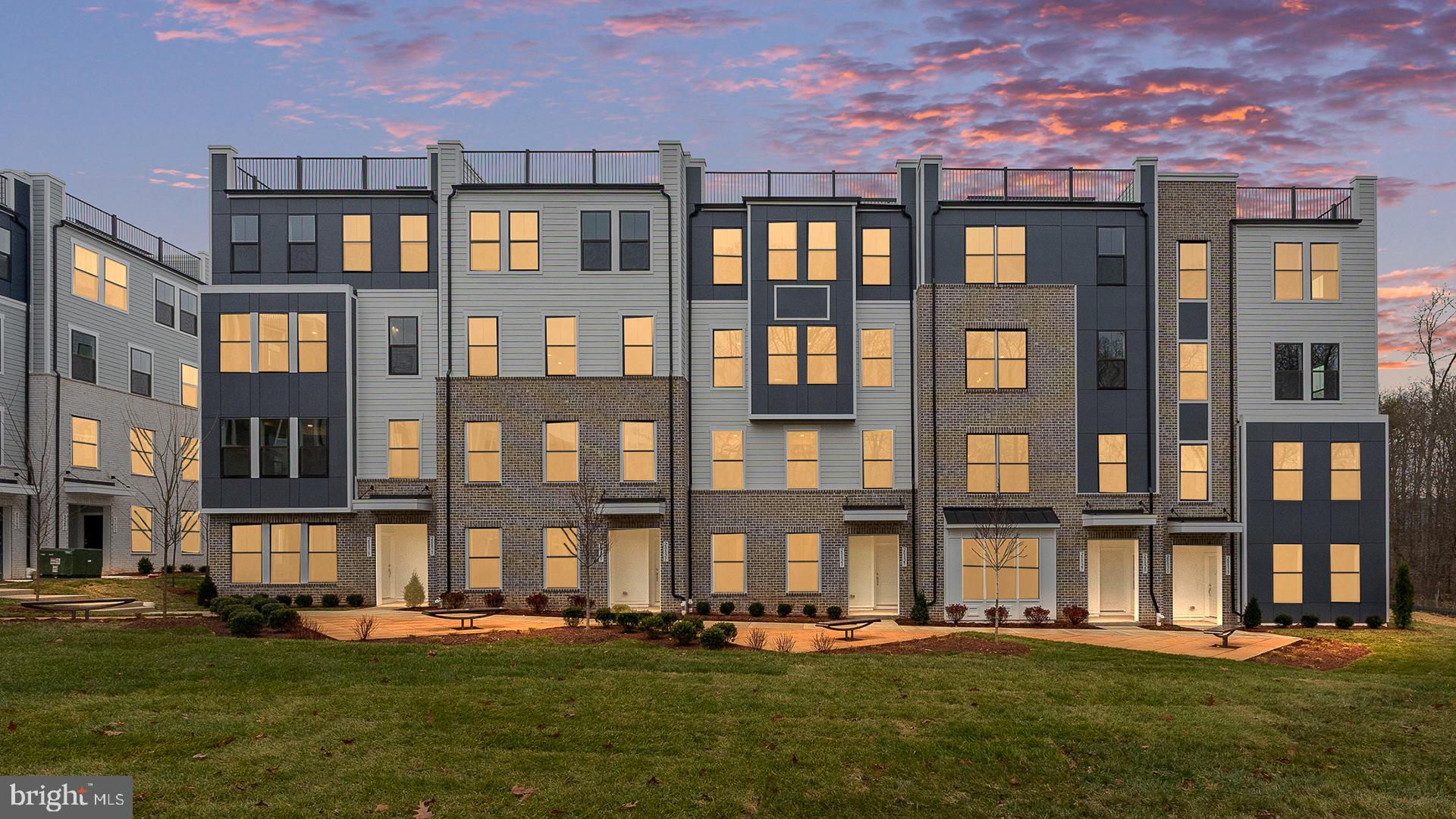 a front view of building with a yard and trees
