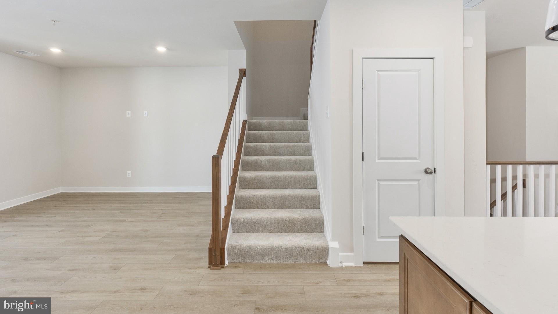 20821 Cloongee Terrace Sterling, VA 20166 - Photo 14 of 34 a view of hallway with stairs and wooden floor
