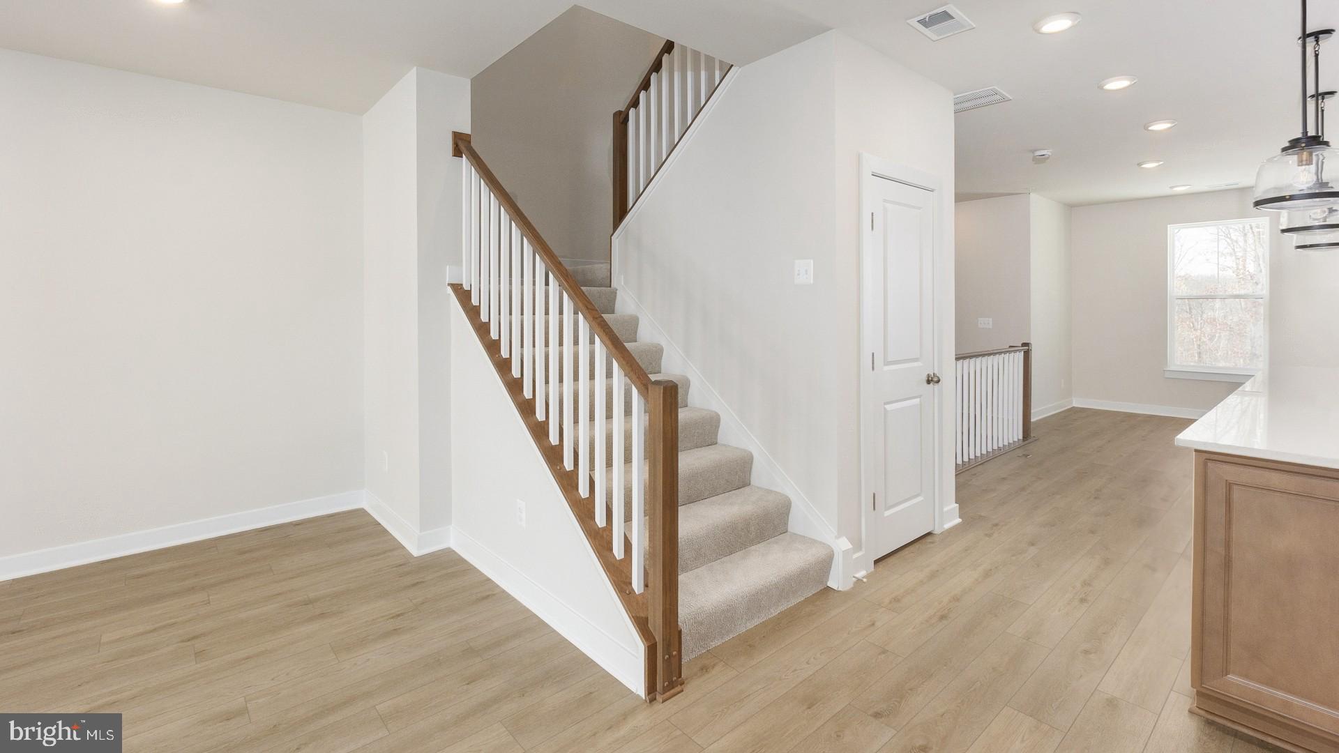 20821 Cloongee Terrace Sterling, VA 20166 - Photo 15 of 34 a view of a hallway with wooden floor and staircase