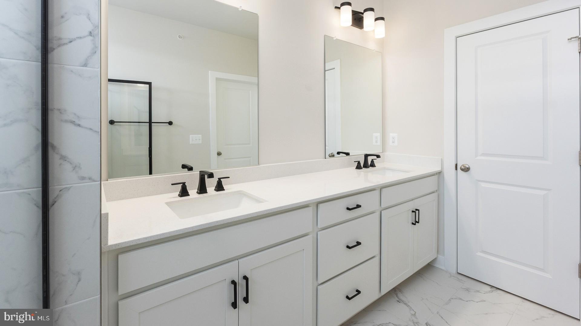 20821 Cloongee Terrace Sterling, VA 20166 - Photo 23 of 34 a bathroom with double sink and a mirror
