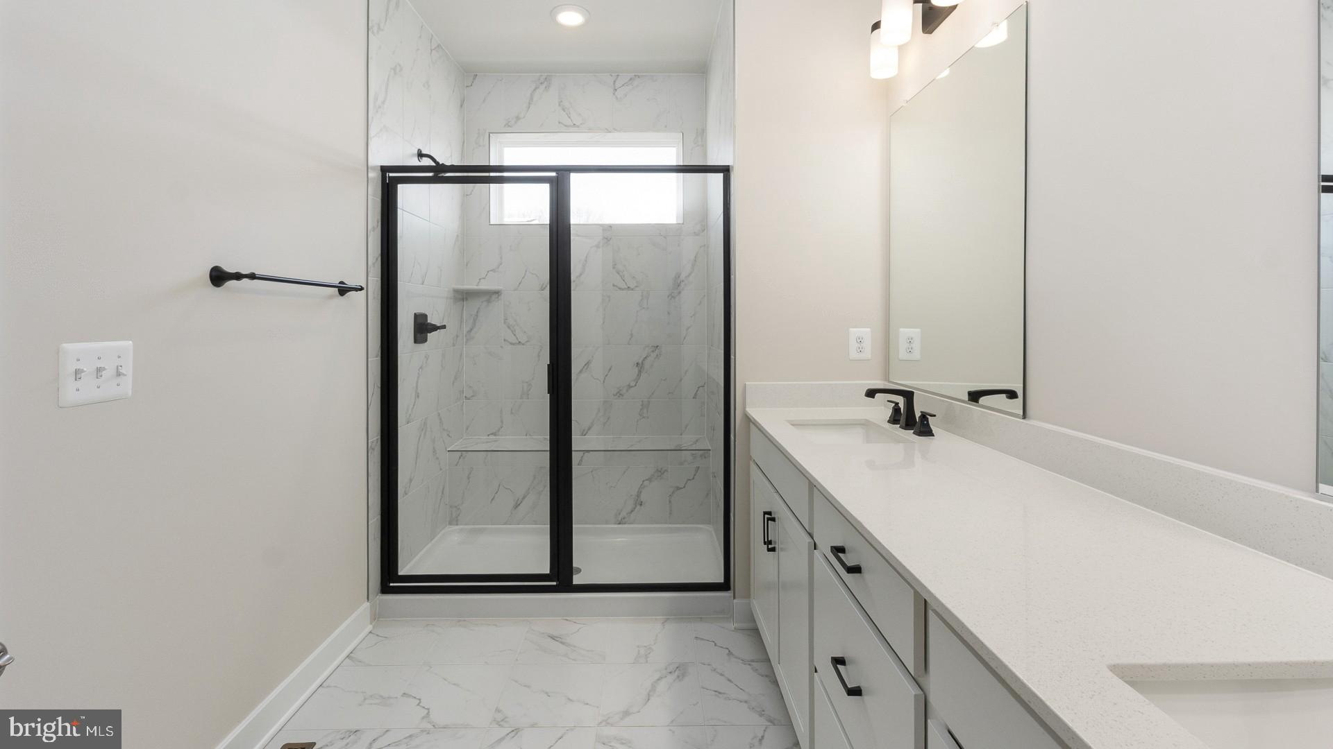 20821 Cloongee Terrace Sterling, VA 20166 - Photo 25 of 34 a bathroom with a double vanity sink and mirror