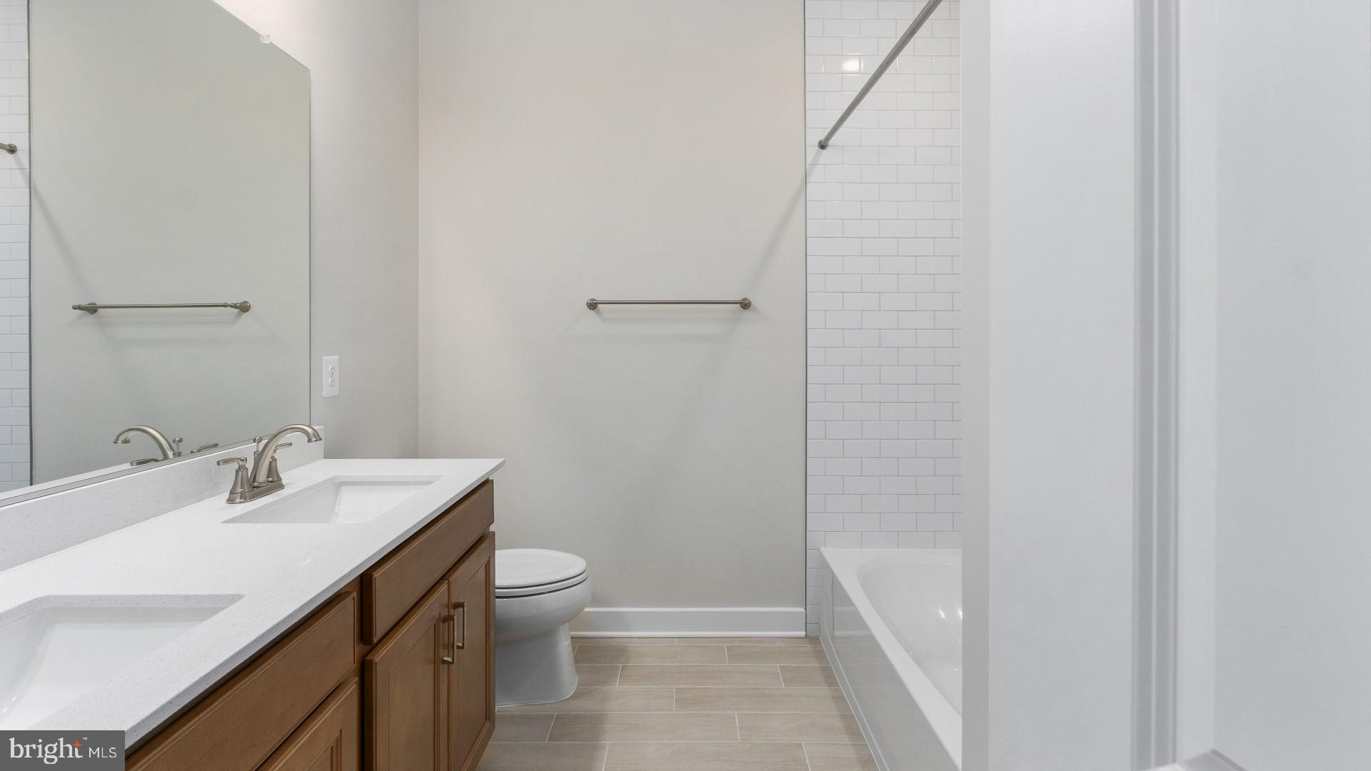 20821 Cloongee Terrace Sterling, VA 20166 - Photo 31 of 34 a bathroom with a sink a toilet and shower