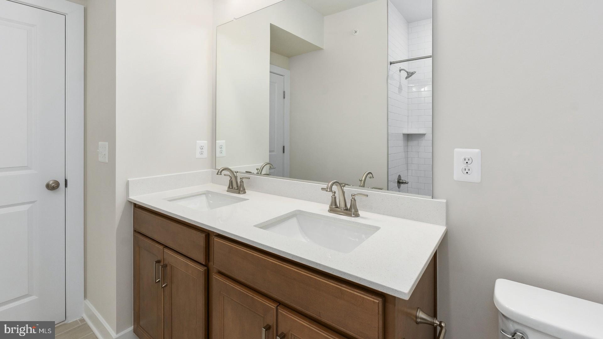 20821 Cloongee Terrace Sterling, VA 20166 - Photo 32 of 34 a bathroom with a sink vanity and a toilet