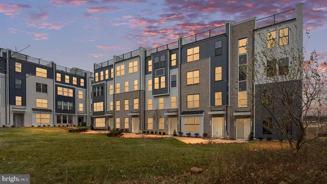a front view of building with outdoor space and trees