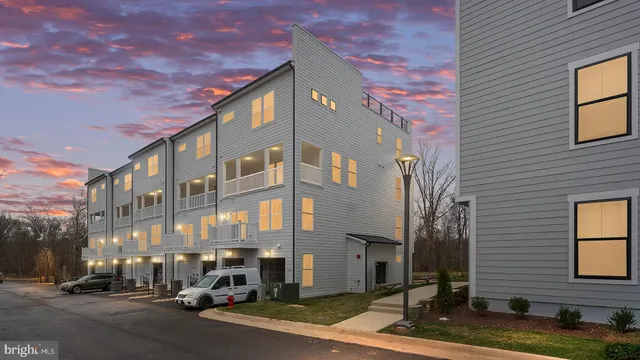 a city street lined with parked cars and buildings
