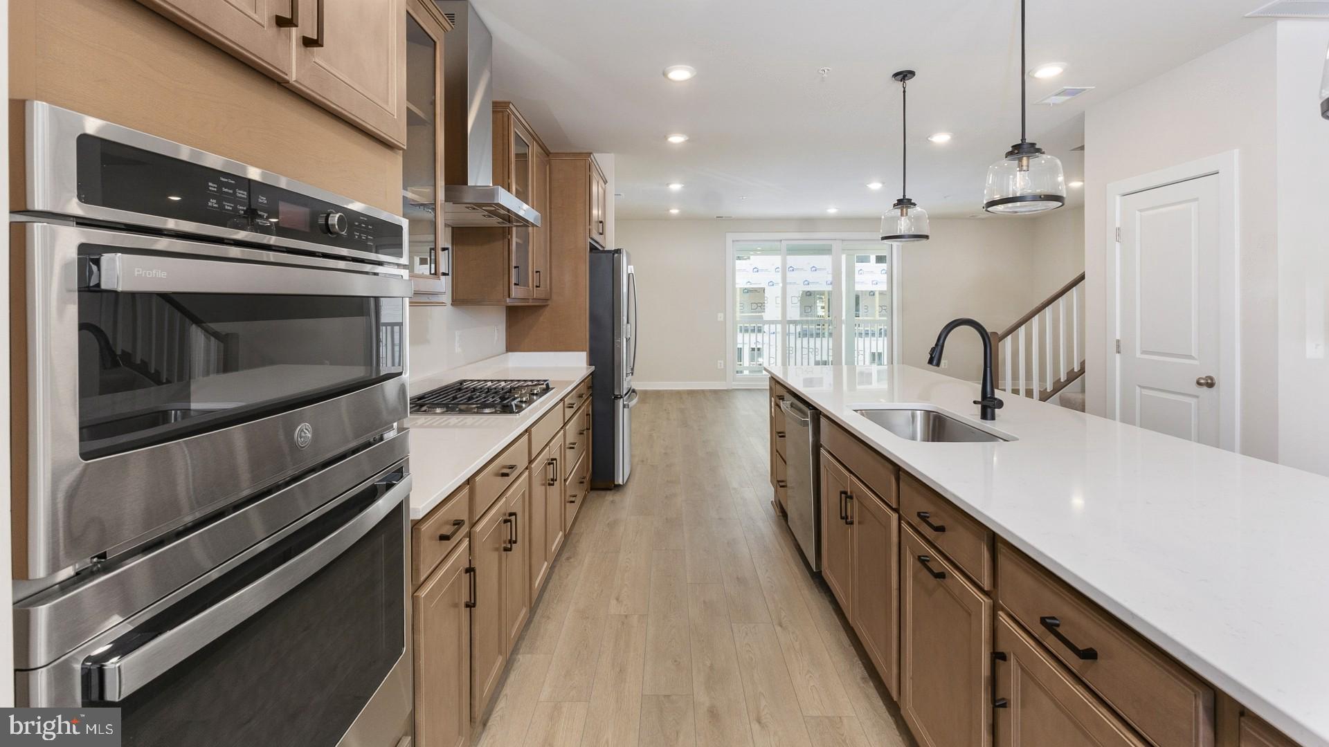 20821 Cloongee Terrace Sterling, VA 20166 - Photo 9 of 34 a kitchen with stainless steel appliances sink a stove and cabinets