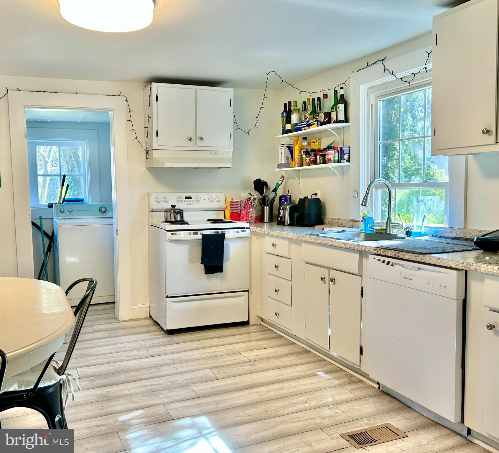 6 Cedar Avenue Towson, MD 21286 - Photo 4 of 10 a kitchen with stainless steel appliances a stove a sink cabinets and a window