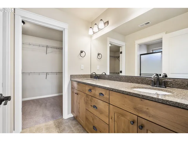 a bathroom with a granite countertop sink mirror and double