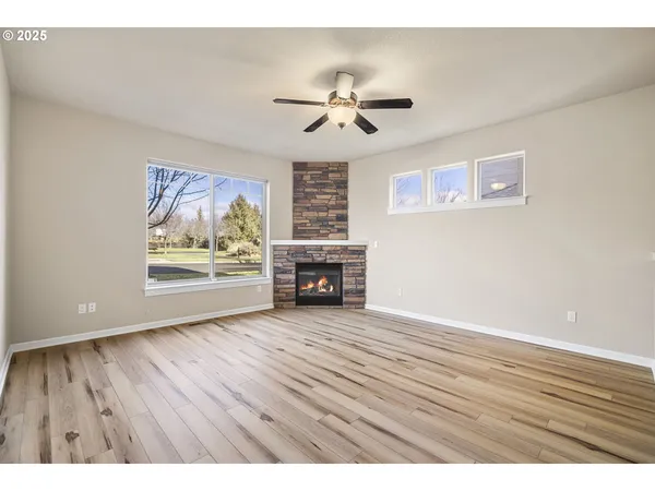 wooden floor in an empty room with a fireplace