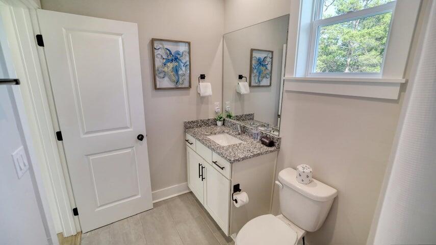 181 Valdare Ln Inlet Beach Inlet Beach, FL 32461 - Photo 20 of 32 a spacious bathroom with a granite countertop toilet sink and mirror