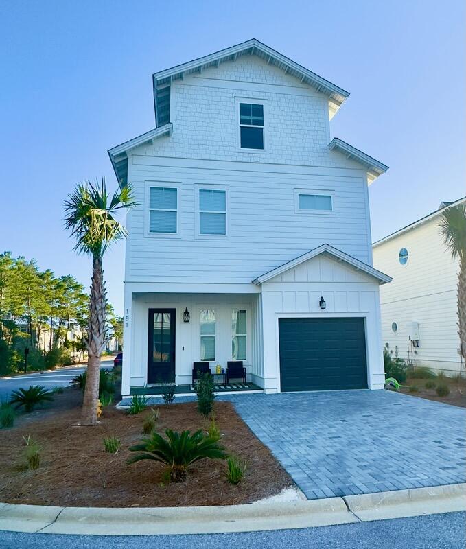 181 Valdare Ln Inlet Beach Inlet Beach, FL 32461 - Photo 2 of 32 a front view of a house with a yard and garage