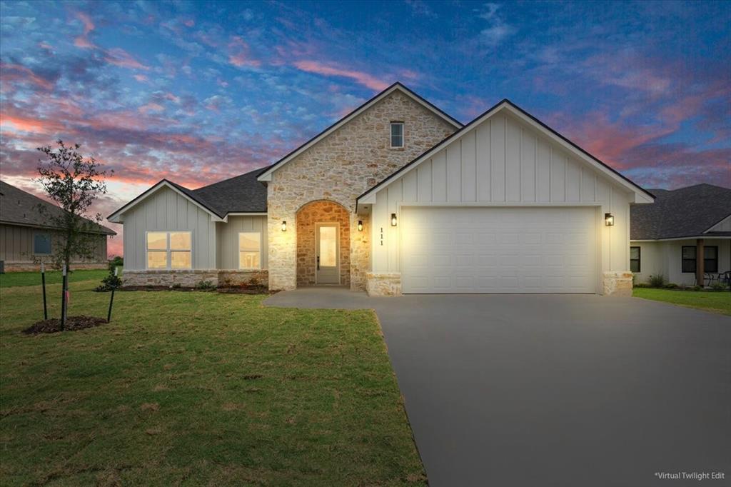 111 Great Trail Road Riesel, TX 76682 - Photo 1 of 1 View of front of home with board and batten siding, concrete driveway, an attached garage, and stone siding