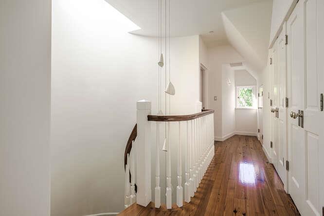 236 Clark Drive San Mateo, CA 94402 - Photo 33 of 58 a view of a hallway with wooden floor and staircase