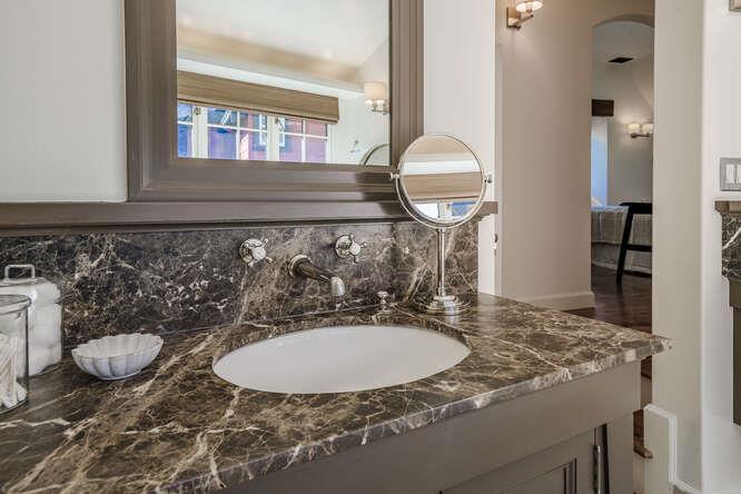 236 Clark Drive San Mateo, CA 94402 - Photo 38 of 58 a bathroom with a granite countertop sink and a mirror