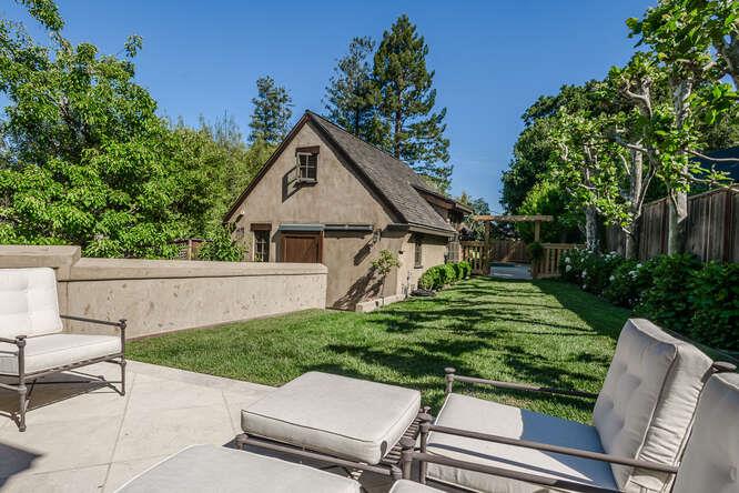 236 Clark Drive San Mateo, CA 94402 - Photo 50 of 58 a view of a white house with a yard and sitting area