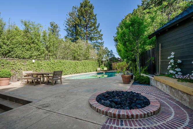 236 Clark Drive San Mateo, CA 94402 - Photo 52 of 58 a view of a backyard with table and chairs couches under an umbrella
