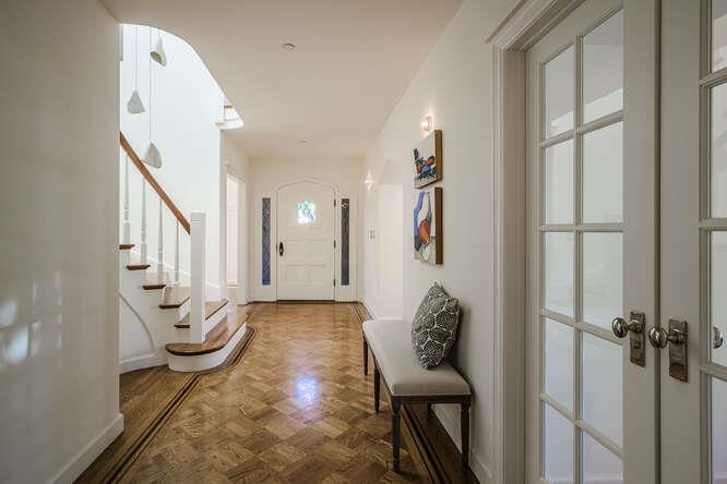 236 Clark Drive San Mateo, CA 94402 - Photo 6 of 58 a view of a hallway with wooden floor and stairs