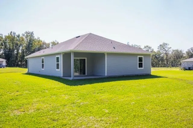 a view of a house with pool and a yard