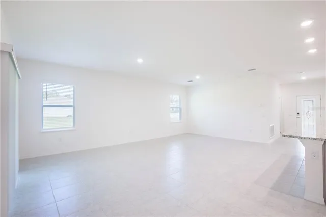 an empty room with a empty space and windows