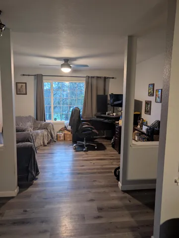 a living room with furniture and a wooden floor