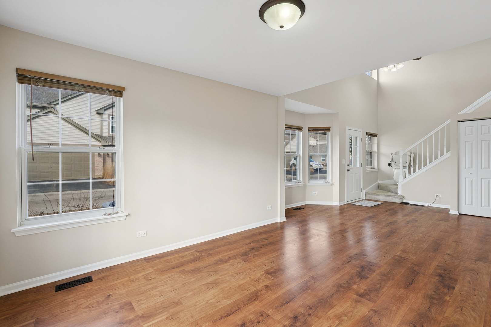 961 Sumac Court Lindenhurst, IL 60046 - Photo 11 of 22 a view of an empty room with wooden floor and a window