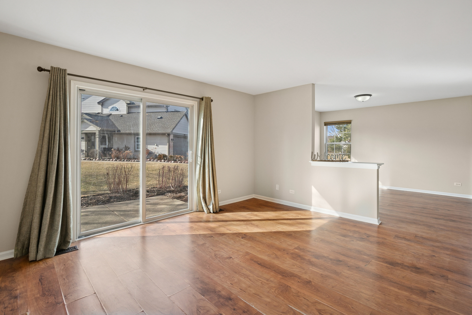 961 Sumac Court Lindenhurst, IL 60046 - Photo 9 of 22 an empty room with wooden floor and windows