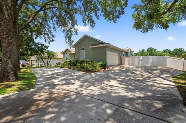 a view of a house with a tree in a yard