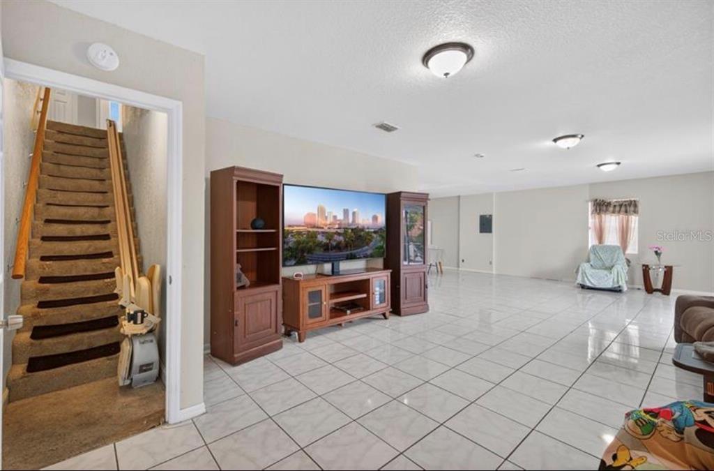 1922 Matthew Court Lakeland, FL 33813 - Photo 7 of 12 a living room with furniture and a flat screen tv