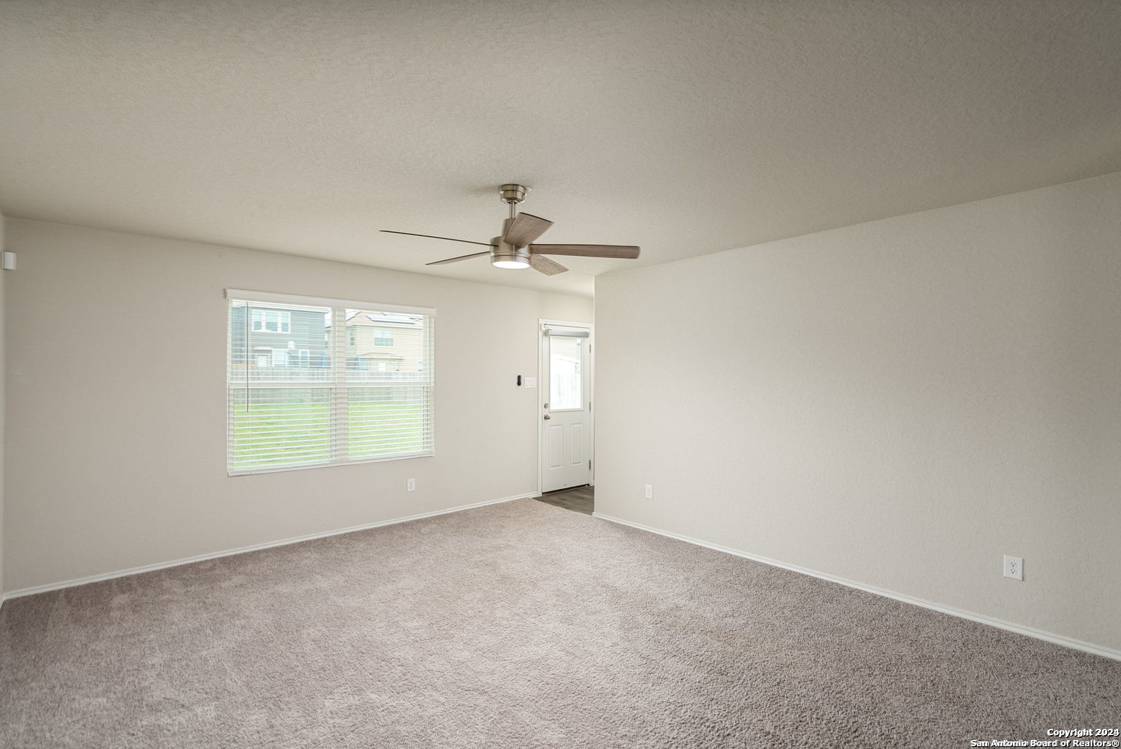 3619 Storm Moon Converse, TX 78109 - Photo 13 of 28 an empty room with windows and ceiling fan view