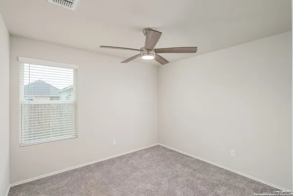 an empty room with a ceiling fan and a ceiling fan