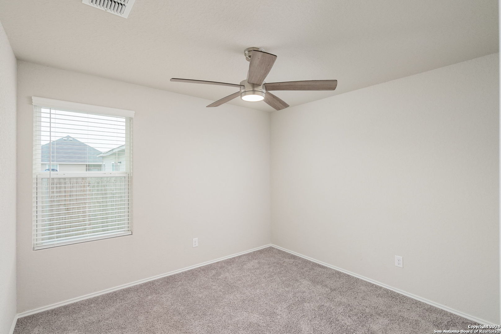 3619 Storm Moon Converse, TX 78109 - Photo 20 of 28 an empty room with a window and a fan