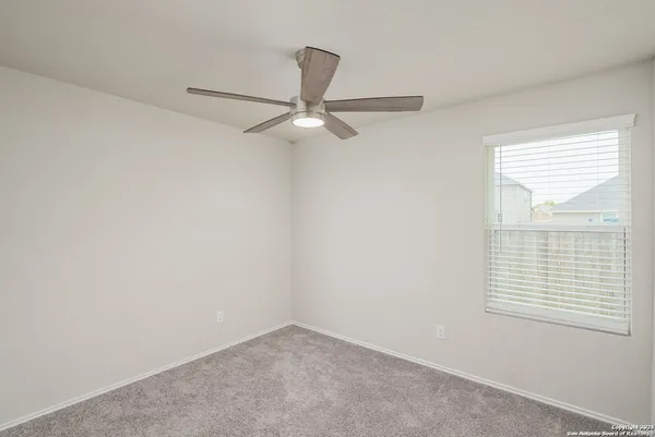 an empty room with a ceiling fan and a ceiling fan