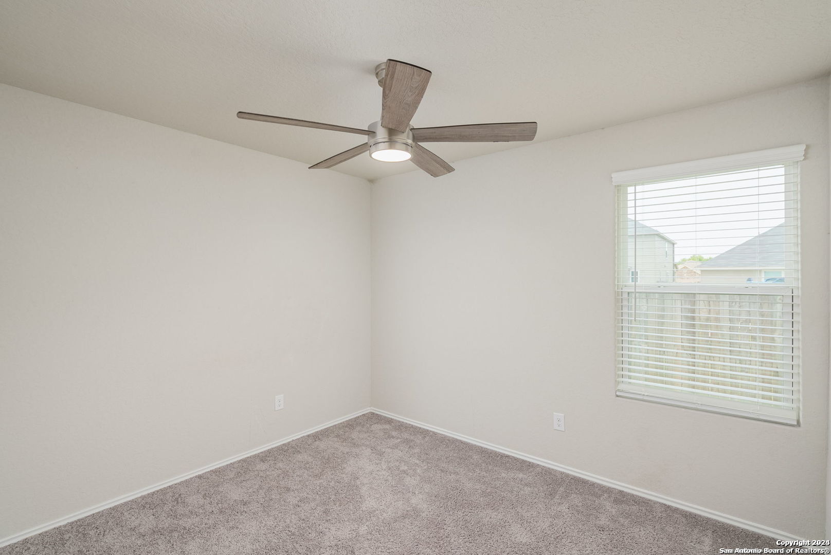 3619 Storm Moon Converse, TX 78109 - Photo 22 of 28 an empty room with a window and a fan