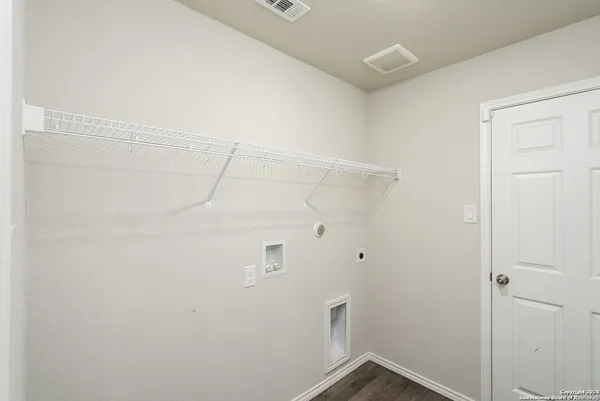 a view of a garden with a house in the background