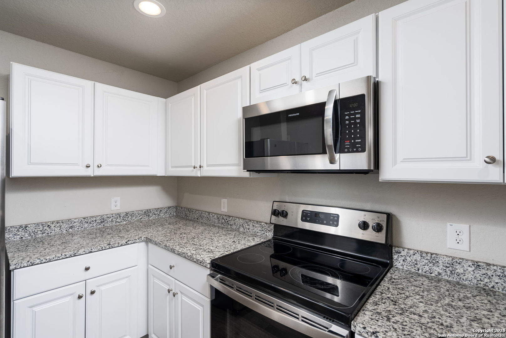 3619 Storm Moon Converse, TX 78109 - Photo 8 of 28 a kitchen with stainless steel appliances granite countertop a sink a stove a microwave and cabinets