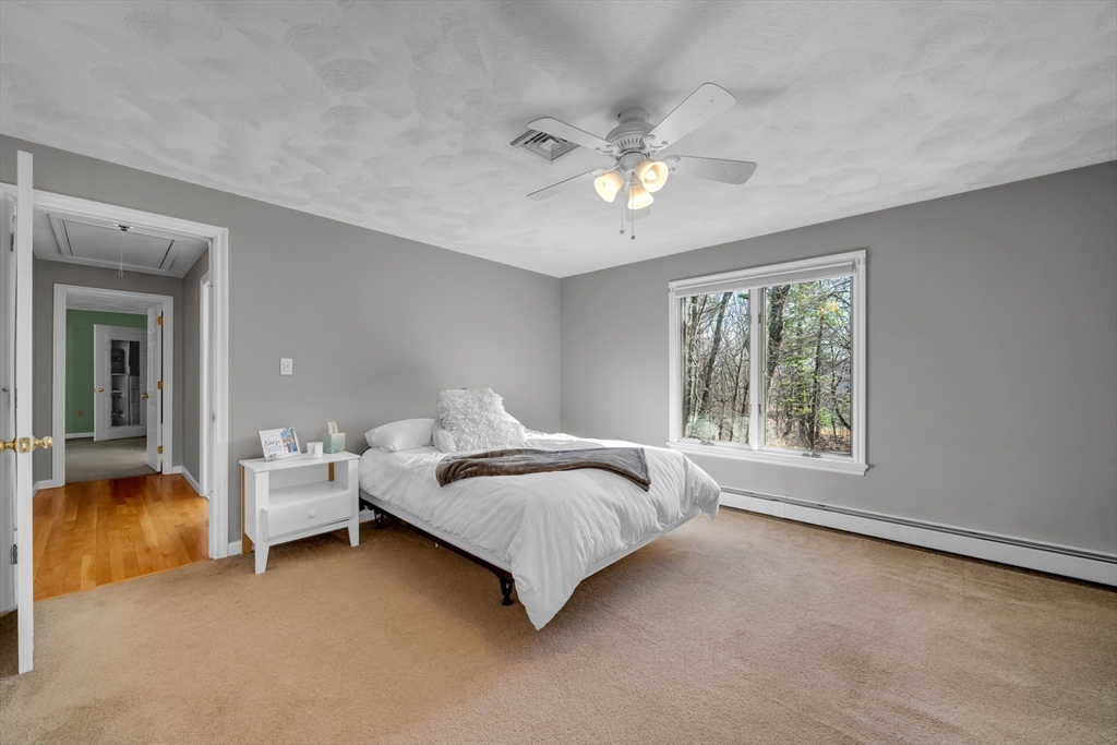315 Candlestick Road North Andover, MA 01845 - Photo 32 of 42 a bed room with a bed and a chandelier