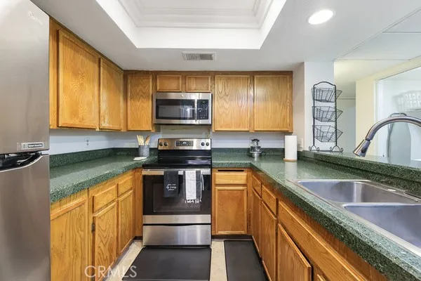 a kitchen with stainless steel appliances a sink stove and cabinets