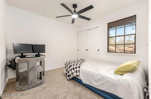 a bedroom with a bed and a television