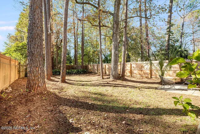 a view of a house with a yard and tree s