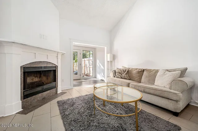a living room with furniture and a fireplace